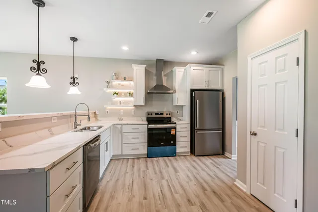 a kitchen with a sink stainless steel appliances and cabinets