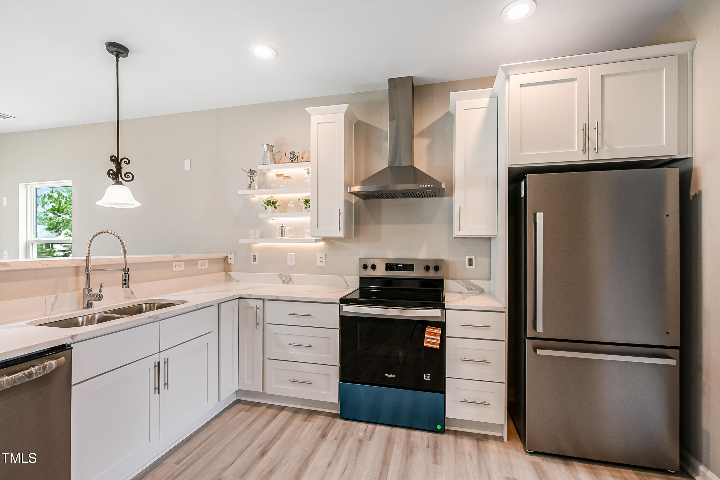 1116 Crendall Way Wake Forest, NC 27587 - Photo 8 of 33 a kitchen with stainless steel appliances a refrigerator sink and cabinets