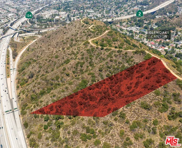 a view of a yard with wooden fence