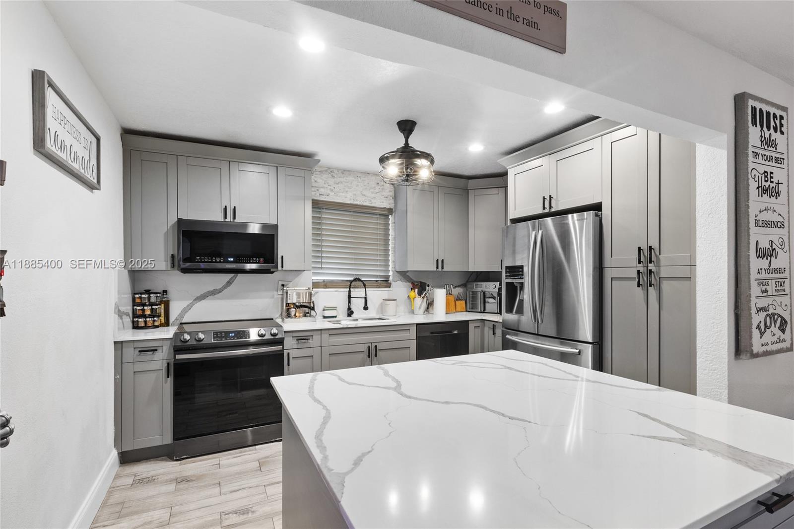 3510 Southwest 87th Avenue Miami, FL 33165 - Photo 2 of 10 a kitchen with stainless steel appliances a refrigerator stove microwave and sink