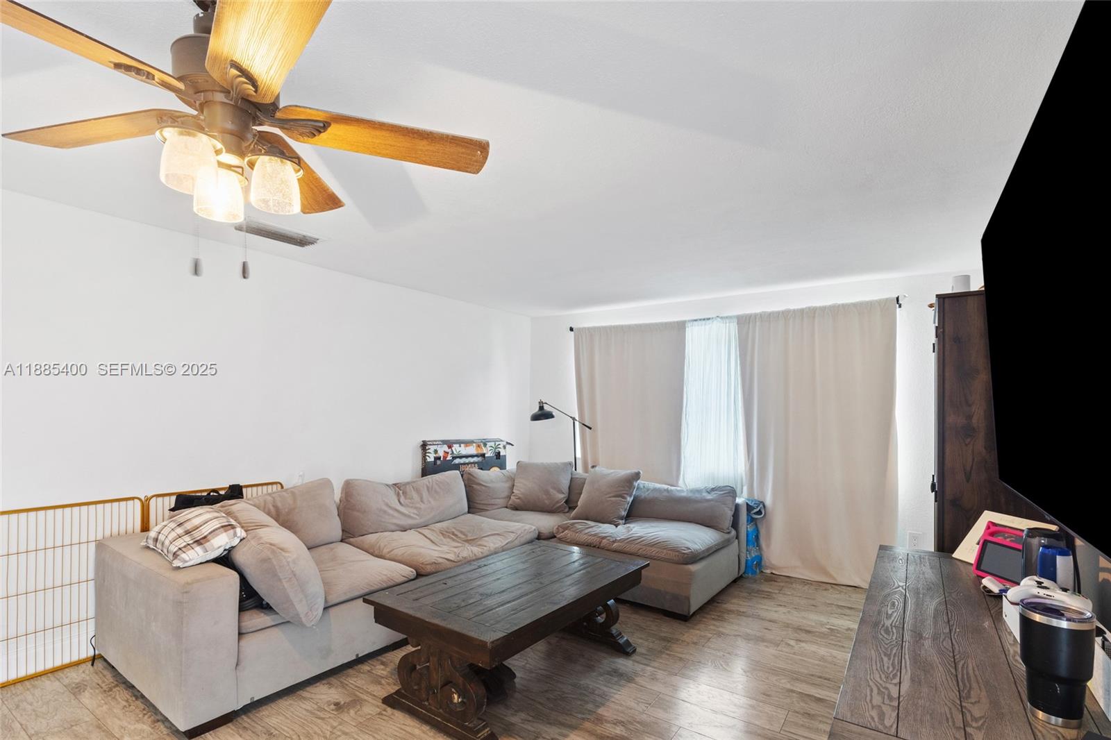 3510 Southwest 87th Avenue Miami, FL 33165 - Photo 3 of 10 a living room with furniture a flat screen tv and a window