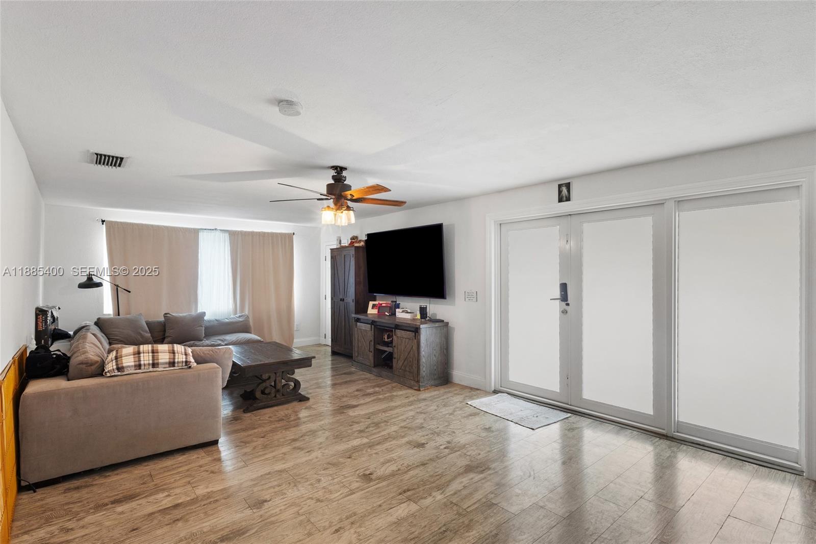 3510 Southwest 87th Avenue Miami, FL 33165 - Photo 4 of 10 a living room with furniture and a flat screen tv