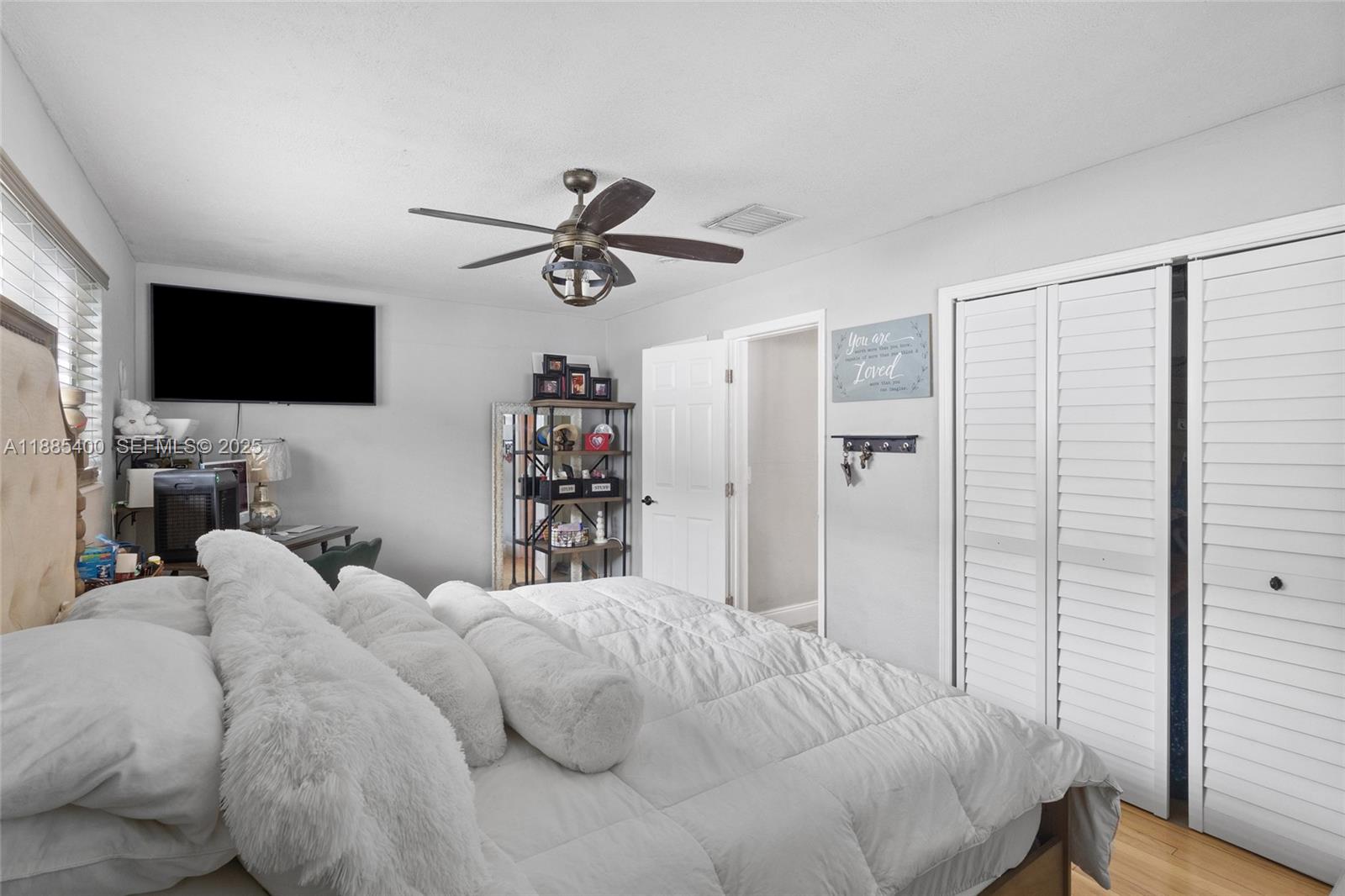 3510 Southwest 87th Avenue Miami, FL 33165 - Photo 7 of 10 a bedroom with a bed a flat screen tv and a window