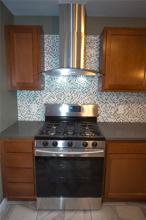 6902 Merton Road Ben Avon, PA 15202 - Photo 14 of 25 Close up of new 5 burner gas range w/ stainless vent hood.