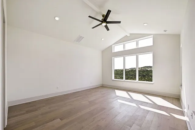 a view of a livingroom with a ceiling fan and window