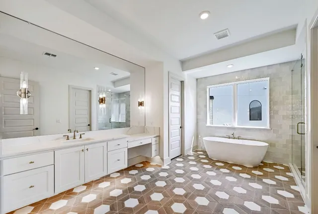 a bathroom with a sink double vanity mirror and a bathtub