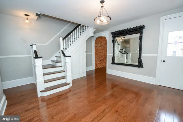 a view of entryway and hall with wooden floor