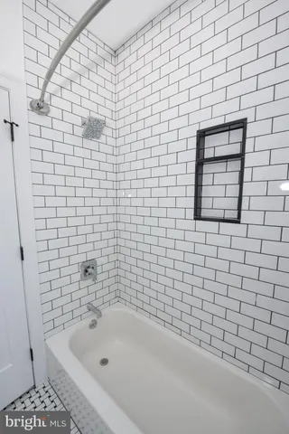 a bathroom with a bathtub and shower