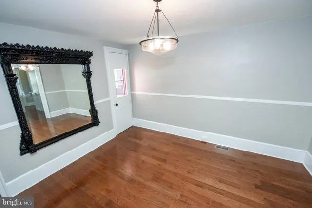 a view of a room with wooden floor and window