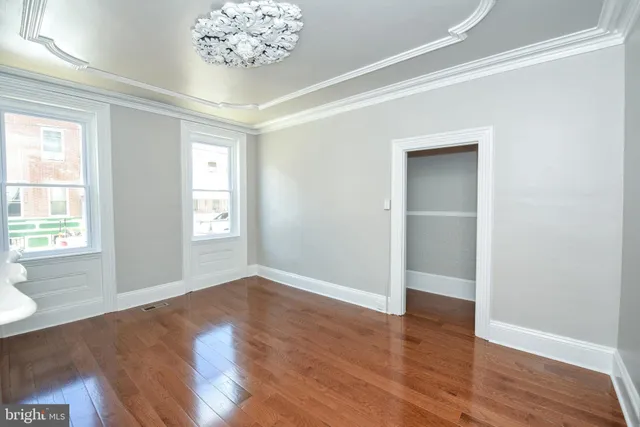wooden floor in an empty room with a window
