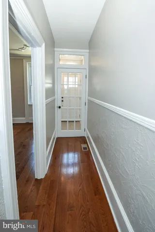 a view of hallway with wooden floor