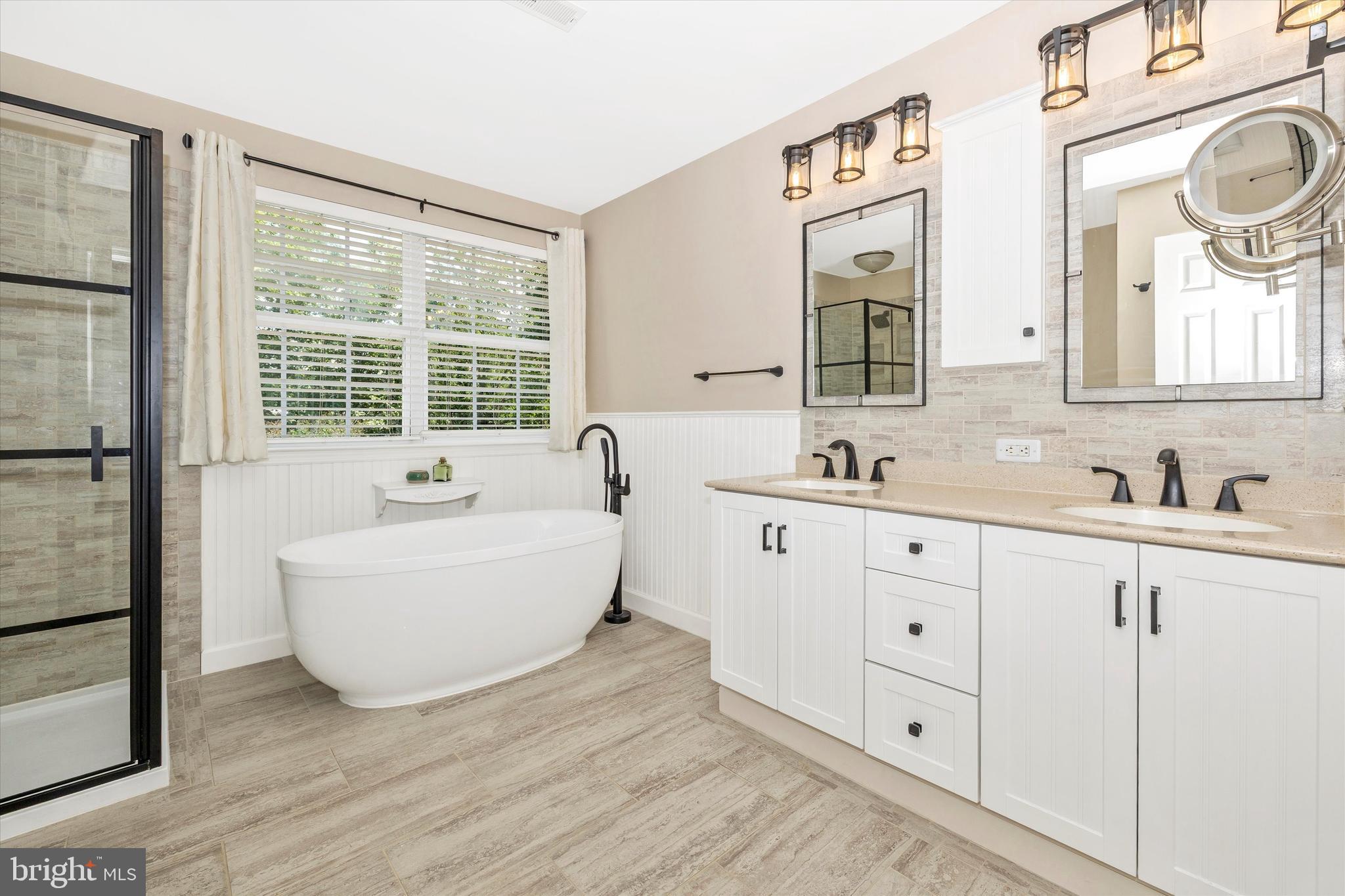 6341 Claridge Drive North Frederick, MD 21701 - Photo 20 of 54 a bathroom with a bathtub sink and mirror