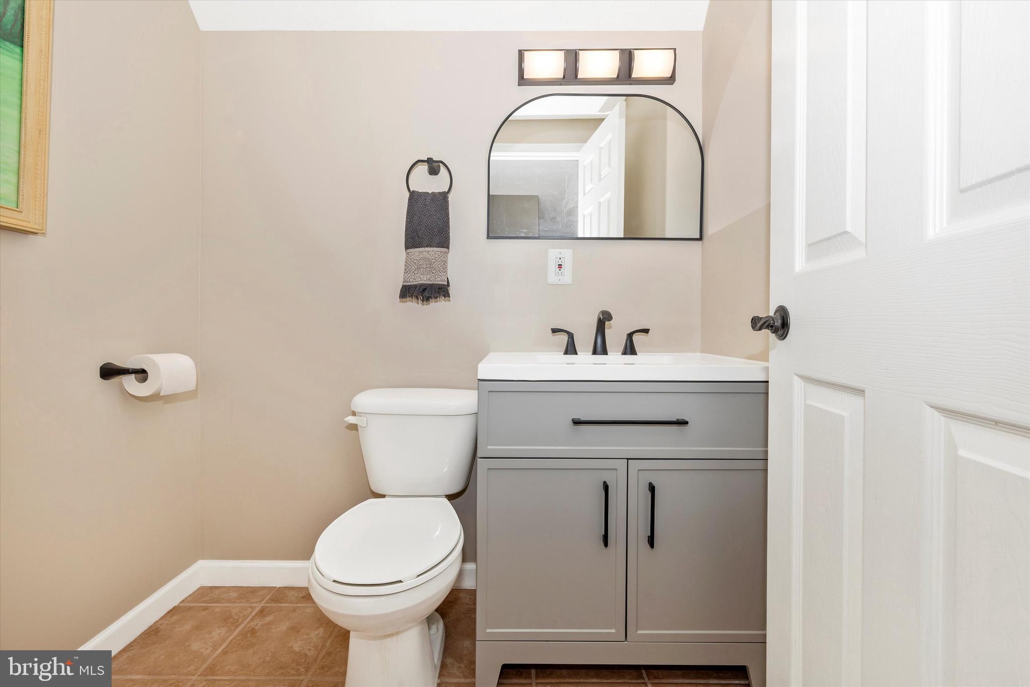 6341 Claridge Drive North Frederick, MD 21701 - Photo 32 of 54 a bathroom with a toilet sink and mirror