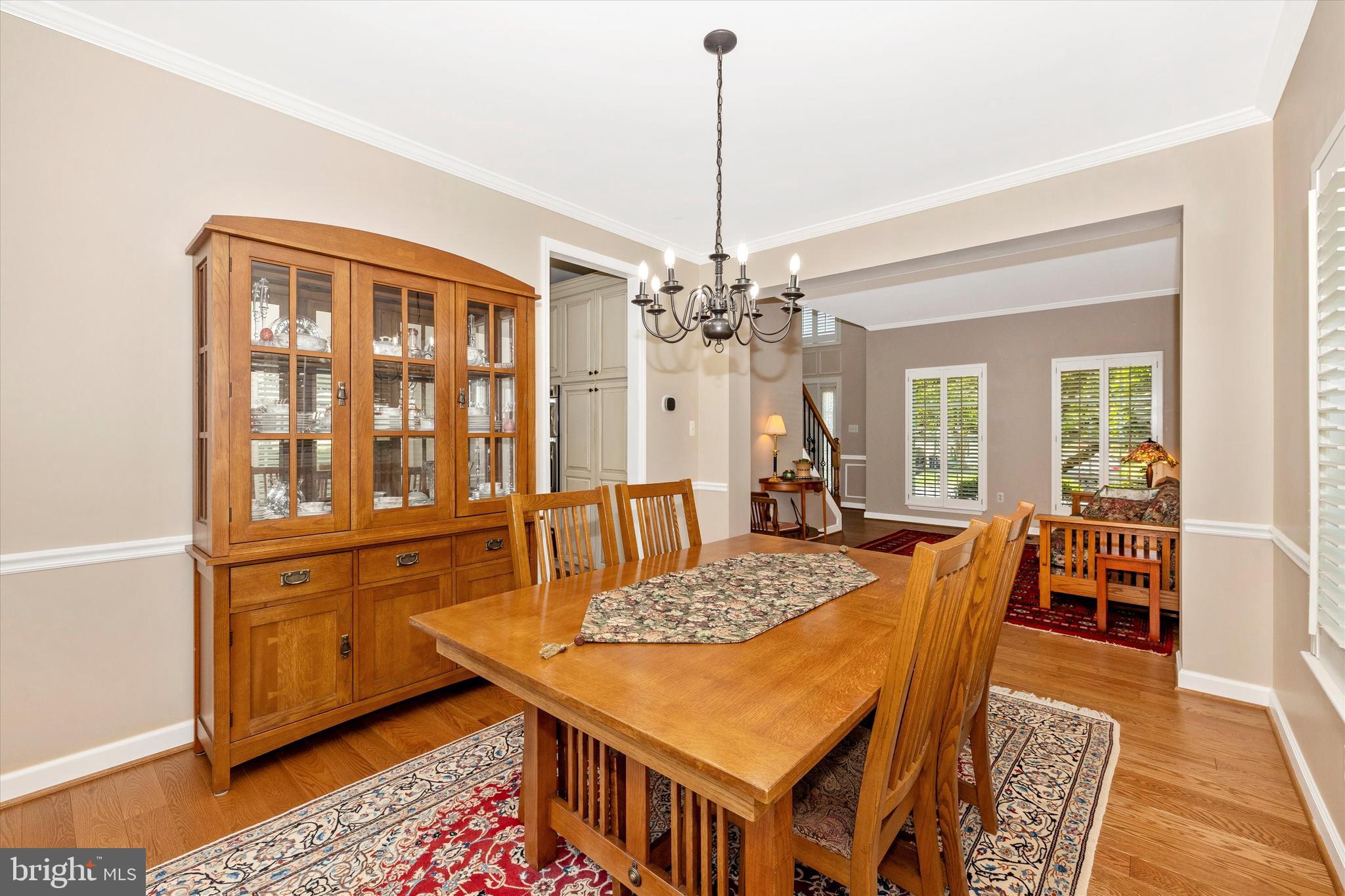 6341 Claridge Drive North Frederick, MD 21701 - Photo 6 of 54 a dining room with furniture a chandelier and wooden floor