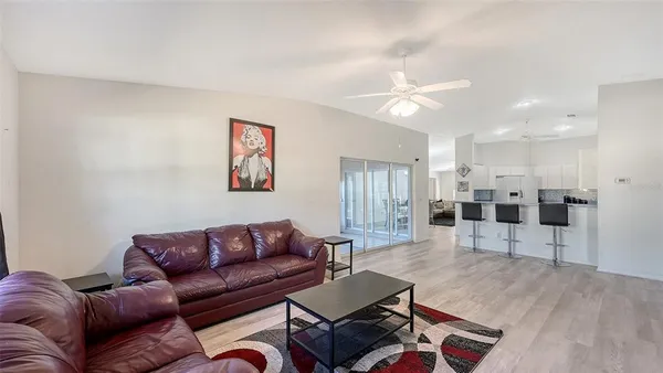 a living room with furniture and kitchen view