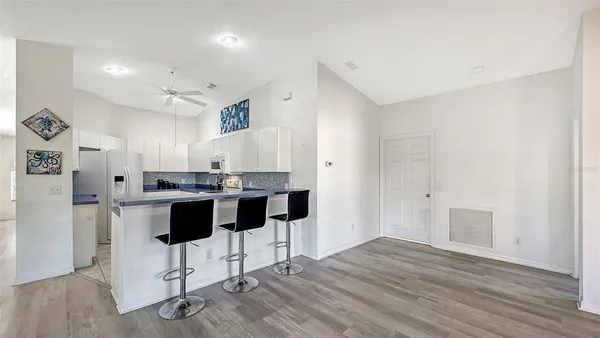 a kitchen with stainless steel appliances kitchen island granite countertop a refrigerator and a stove top oven