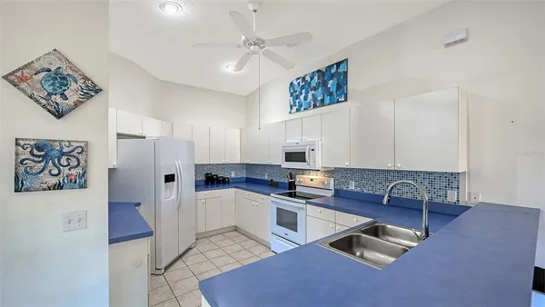 a kitchen with stainless steel appliances granite countertop a refrigerator sink and cabinets