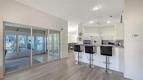 a living room with furniture and a glass door