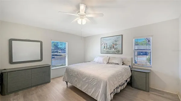 a bedroom with a large bed and a window