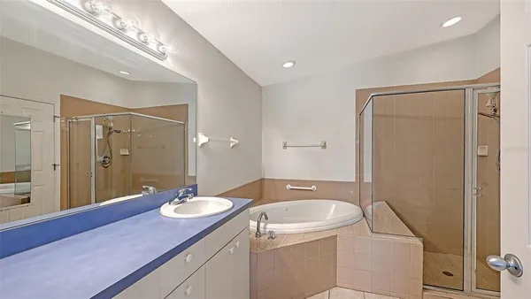 a bathroom with a granite countertop sink a mirror and a shower