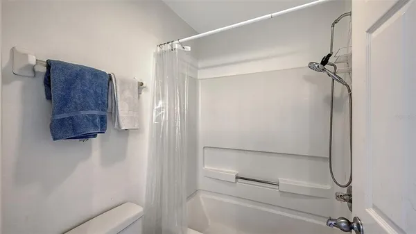 a bathroom with a shower and a toilet