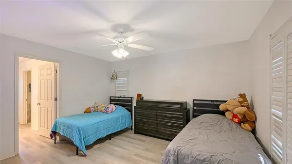 a bedroom with two beds and a chandelier