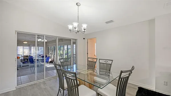 a view of a dining room with furniture wooden floor and chandelier