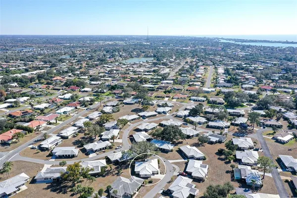an aerial view of residential houses with city view
