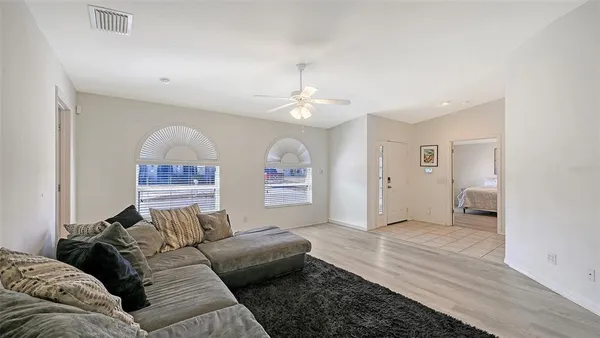 a living room with furniture and a chandelier