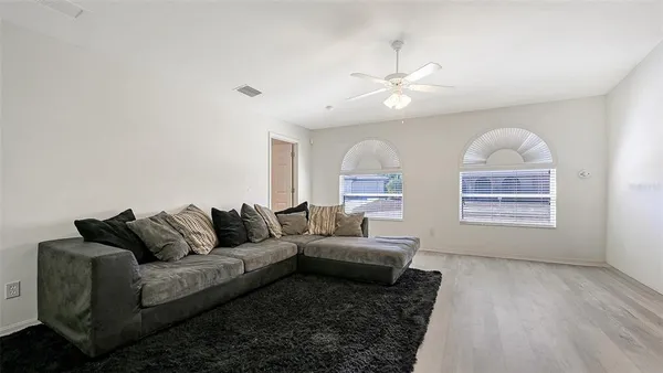 a living room with furniture and a wooden floor
