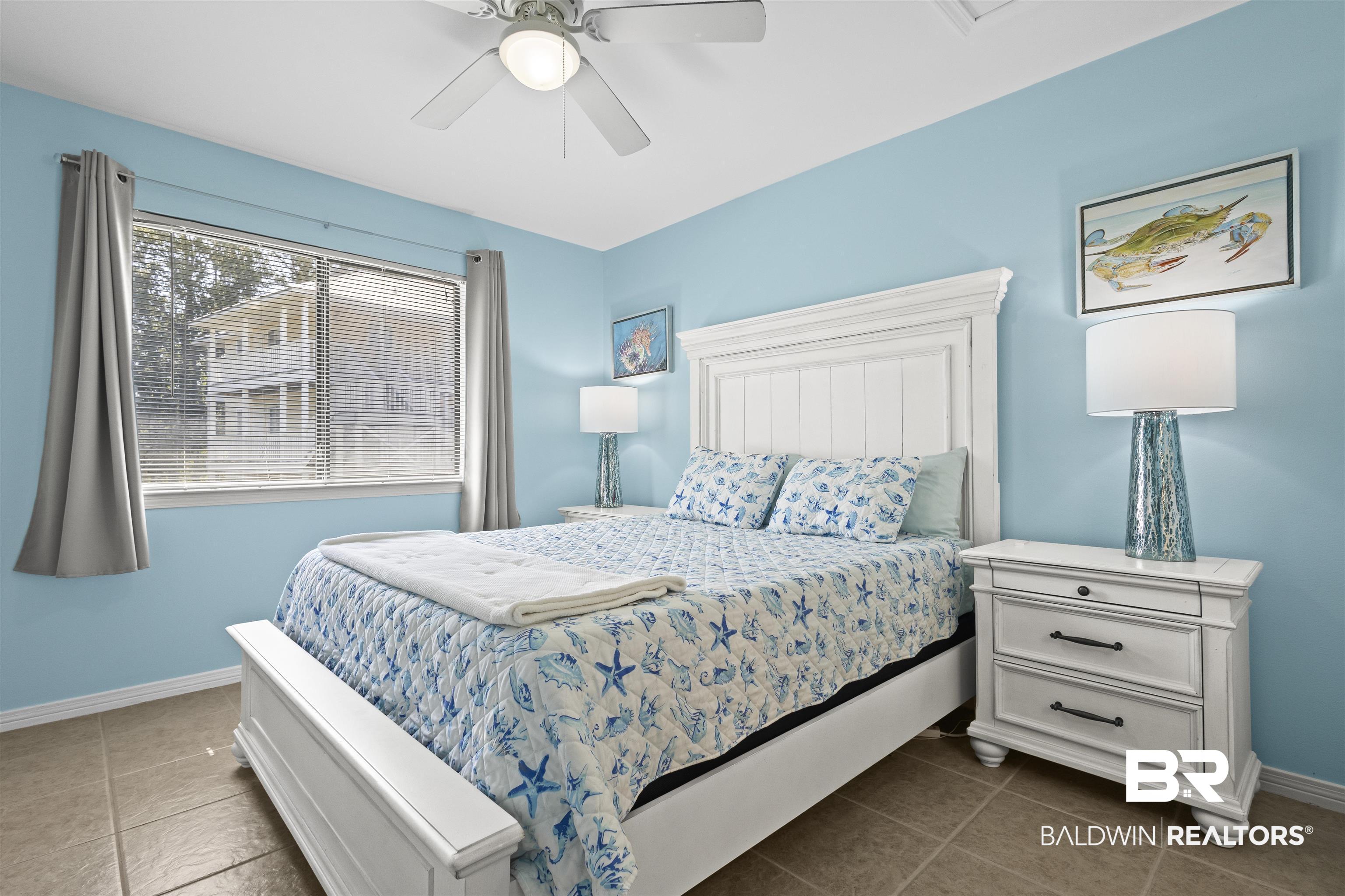 25925 Canal Road, Unit 207 Orange Beach, AL 36561 - Photo 24 of 42 Tiled bedroom with ceiling fan