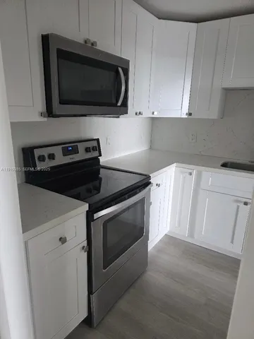 a kitchen with a stove and a microwave