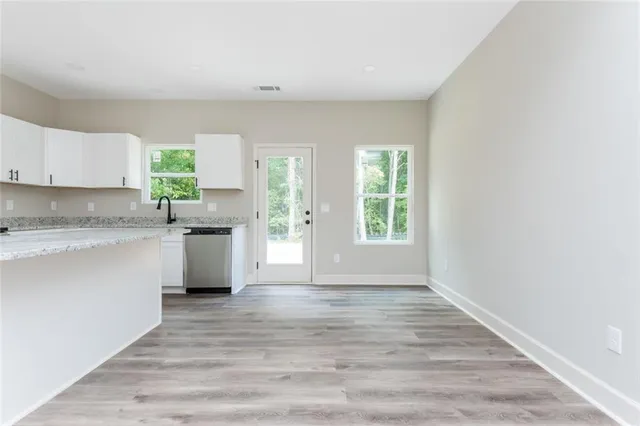 a view of kitchen with wooden floor and electronic appliances