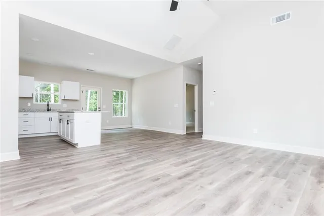 a view of a kitchen with wooden floor and electronic appliances