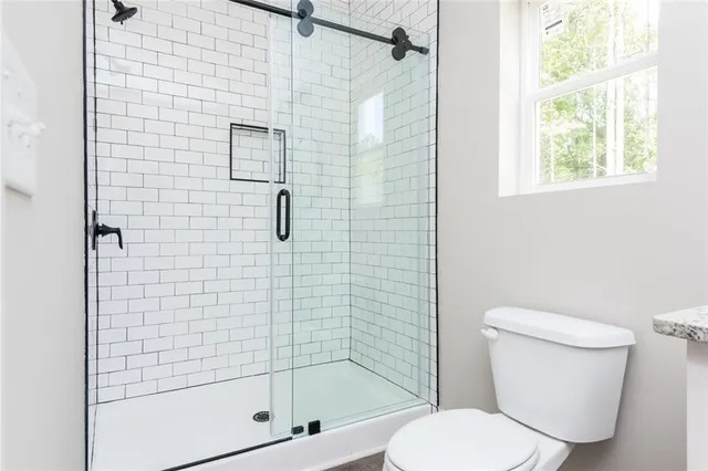 a bathroom with a toilet and shower