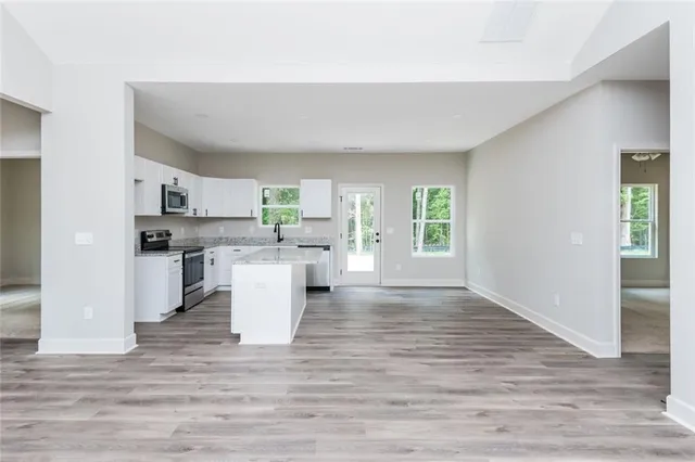 a view of a kitchen with a sink and wooden floor