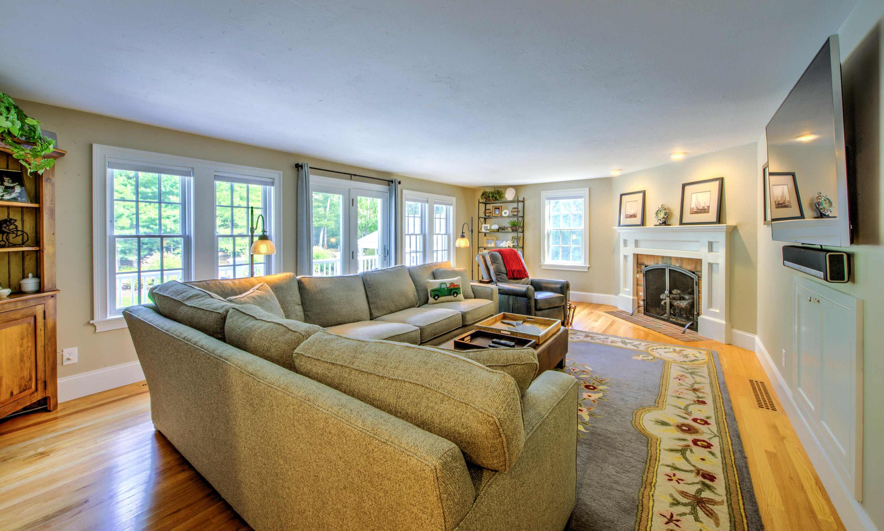 4 Hill Creek Road Centerville, MA 02632 - Photo 14 of 27 a living room with furniture a fireplace and a wooden floor