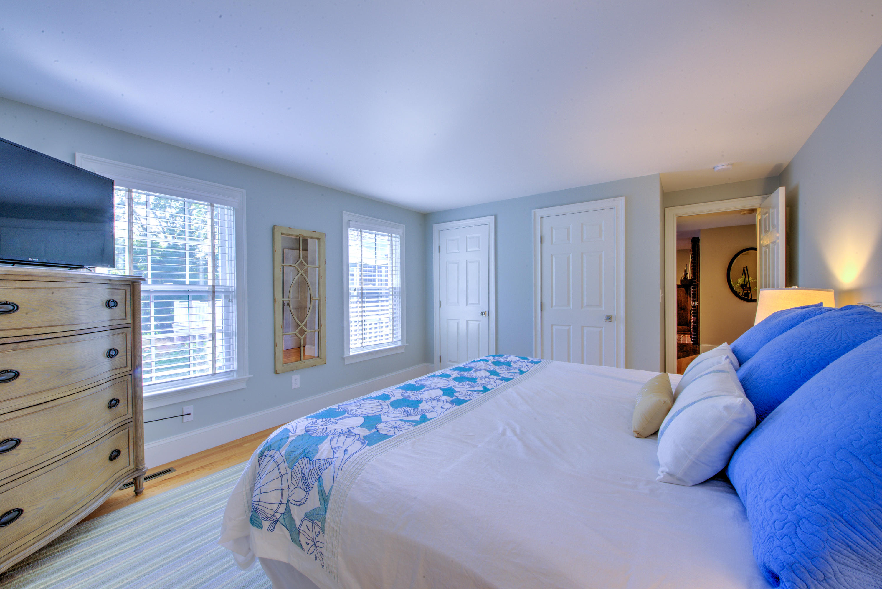 4 Hill Creek Road Centerville, MA 02632 - Photo 19 of 27 a bedroom with a bed and wooden floor