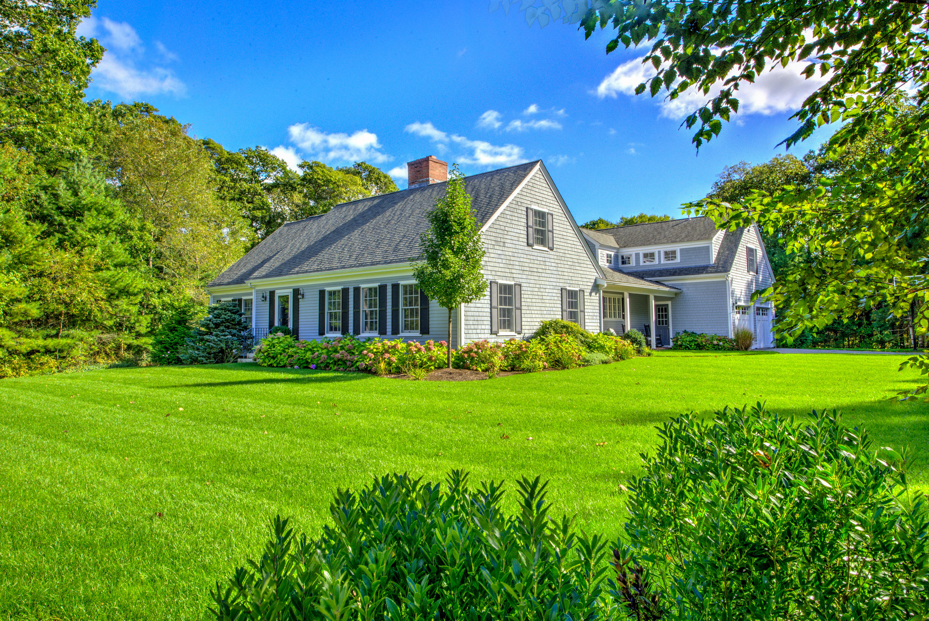 4 Hill Creek Road Centerville, MA 02632 - Photo 2 of 27 a front view of a house with a garden