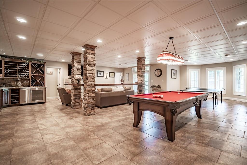 1225 East Hookstown Grade Road Clinton, PA 15026 - Photo 23 of 25 Wine bar, gaming area, custom-made counters, a TV area, a home gym, and access to the home's third suite are just a few of the things this lower level has to offer.