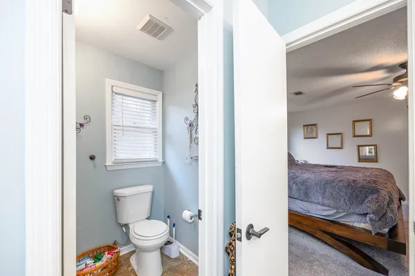 a bathroom with a toilet sink and a mirror