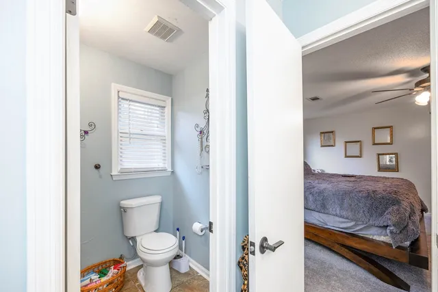 a bathroom with a toilet sink and a mirror