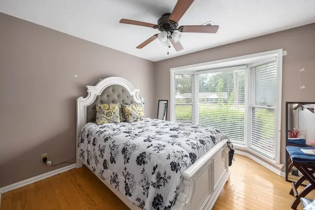 a bedroom with a bed and a ceiling fan