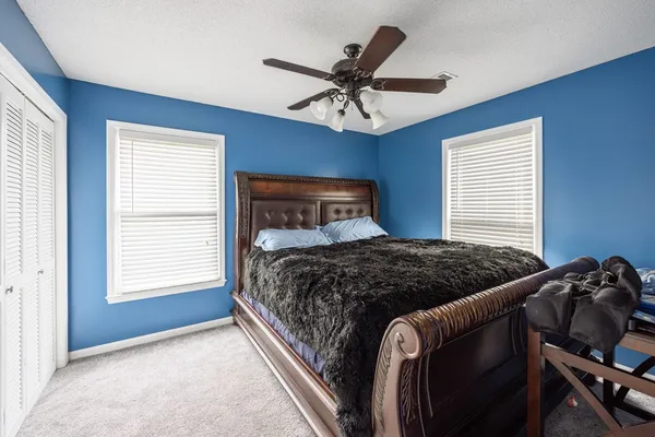 a bedroom with a bed and window