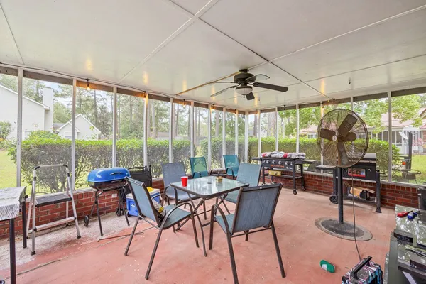 a living room with furniture and floor to ceiling windows