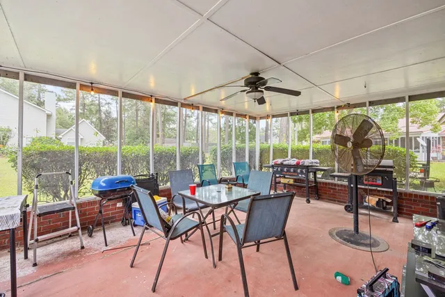 a living room with furniture and floor to ceiling windows