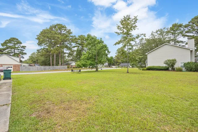 a view of outdoor space with garden and trees