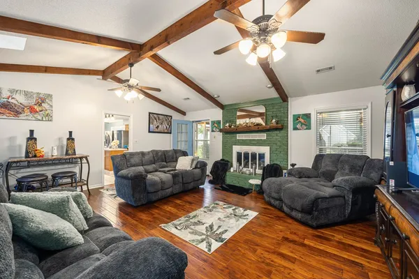 a living room with furniture a fireplace and a chandelier