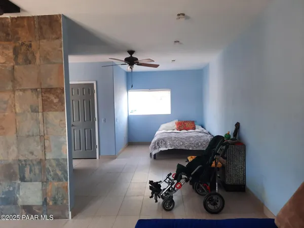 a view of living room filled with furniture and clothes