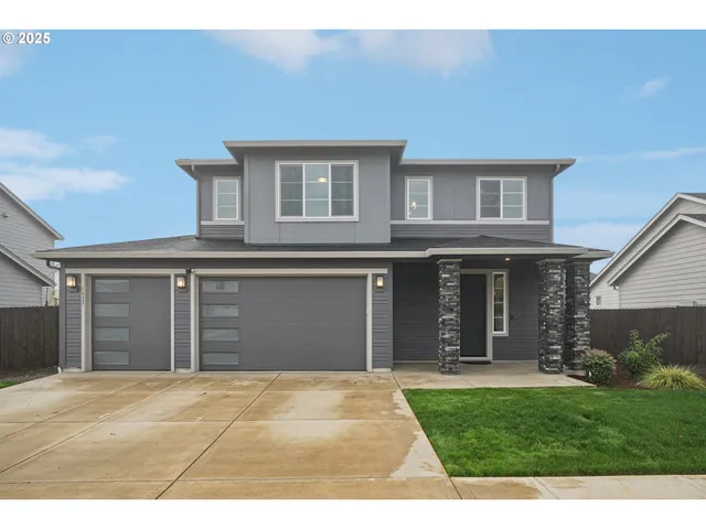 a front view of a house with a yard and garage